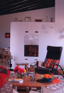 This beautiful plastered fireplace is part of the kitchen and the living room
